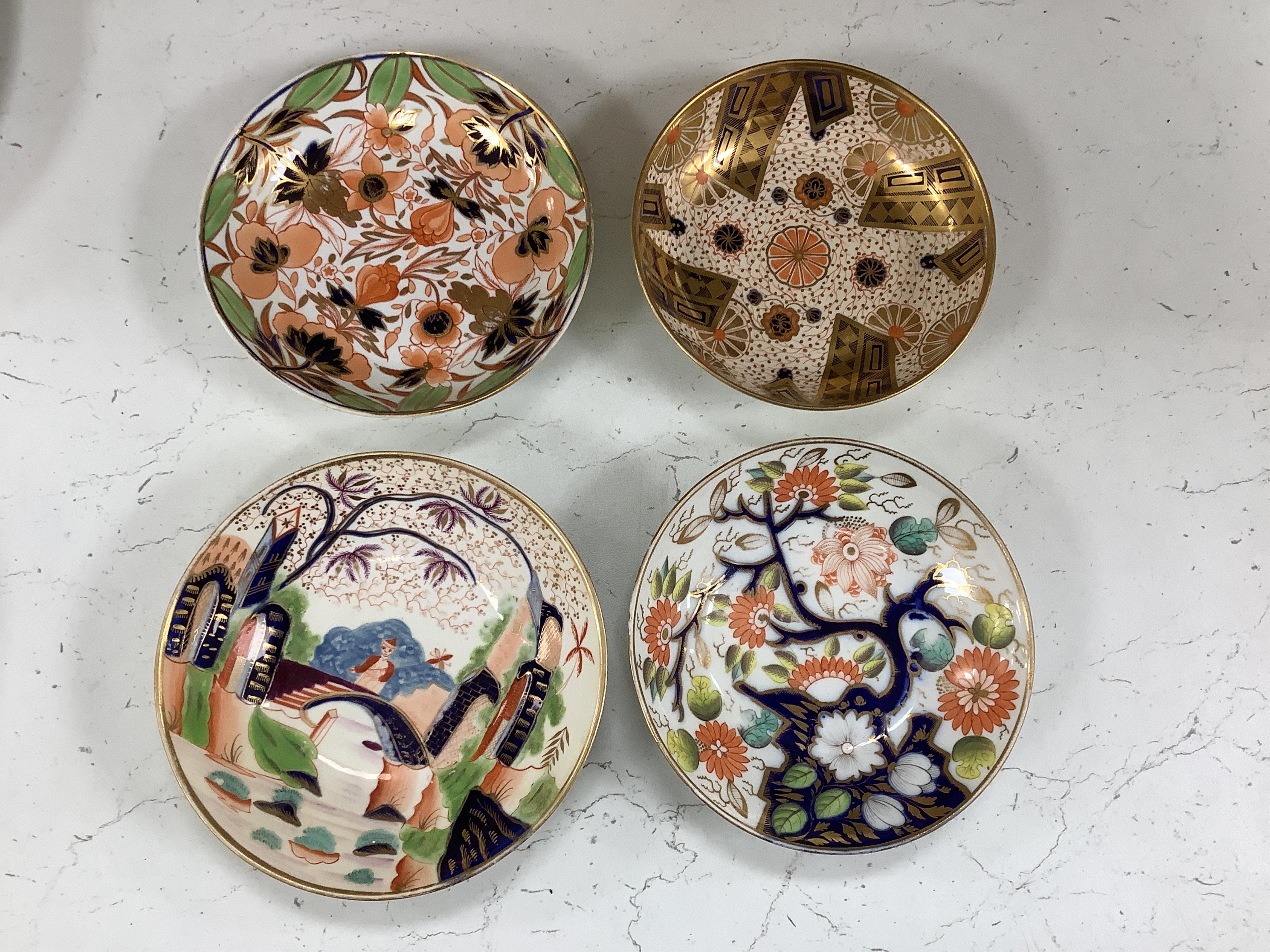 Sixteen mixed items of 1800-1820 English porcelain tableware, to include: three sucriers and covers, an oval ornately decorated dish, four saucer dishes, a candle holder, three spill vases and four saucers